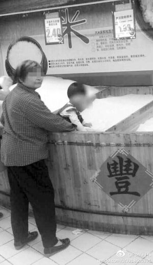 “熊孩子” 将超市米桶当沙滩 在里面玩耍.jpg